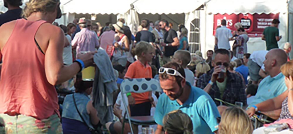 Crowded outdoor event with people socialising
