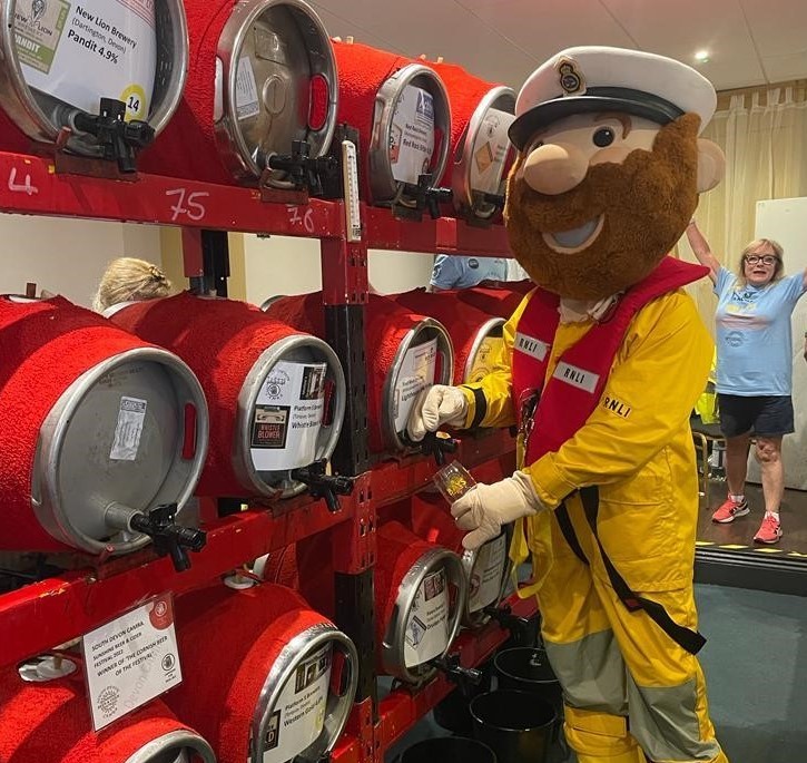 Mascot pouring a drink from a beer keg